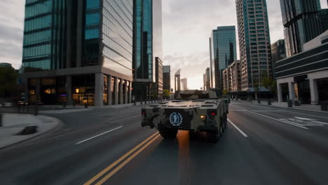 military vehicle in city street at sunset