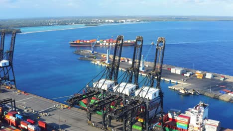 cargo ship at caucedo dp world port, dominican republic. aerial circling