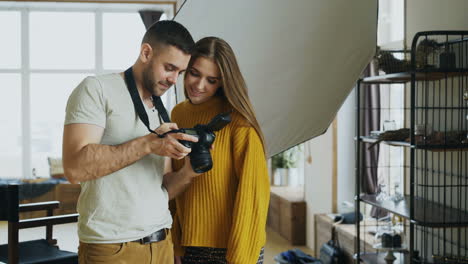photographer teaching a model how to use a camera