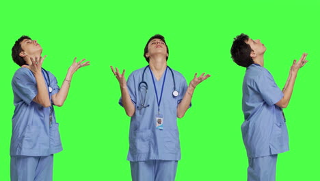 Hospital-nurse-worshipping-God-by-prayer-against-greenscreen-backdrop