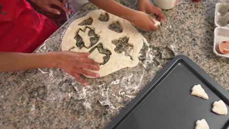 family making christmas cookies at home