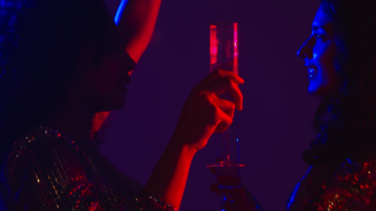 Close Up Of Two Women In Nightclub Bar Or Disco Dancing And Drinking Alcohol 2