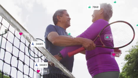 senior tennis players embracing at net, showcasing floating technology social media icons