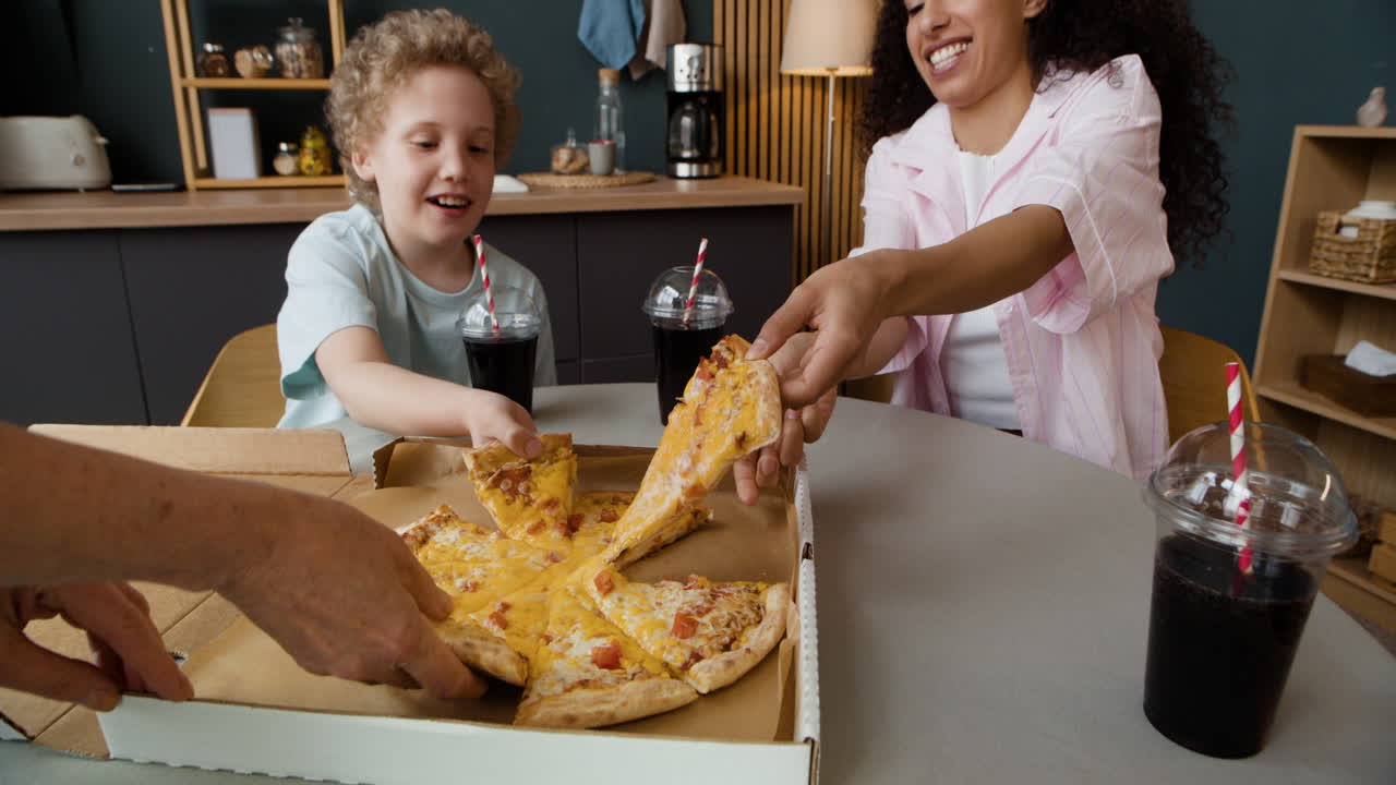 Family sharing pizza and drinks