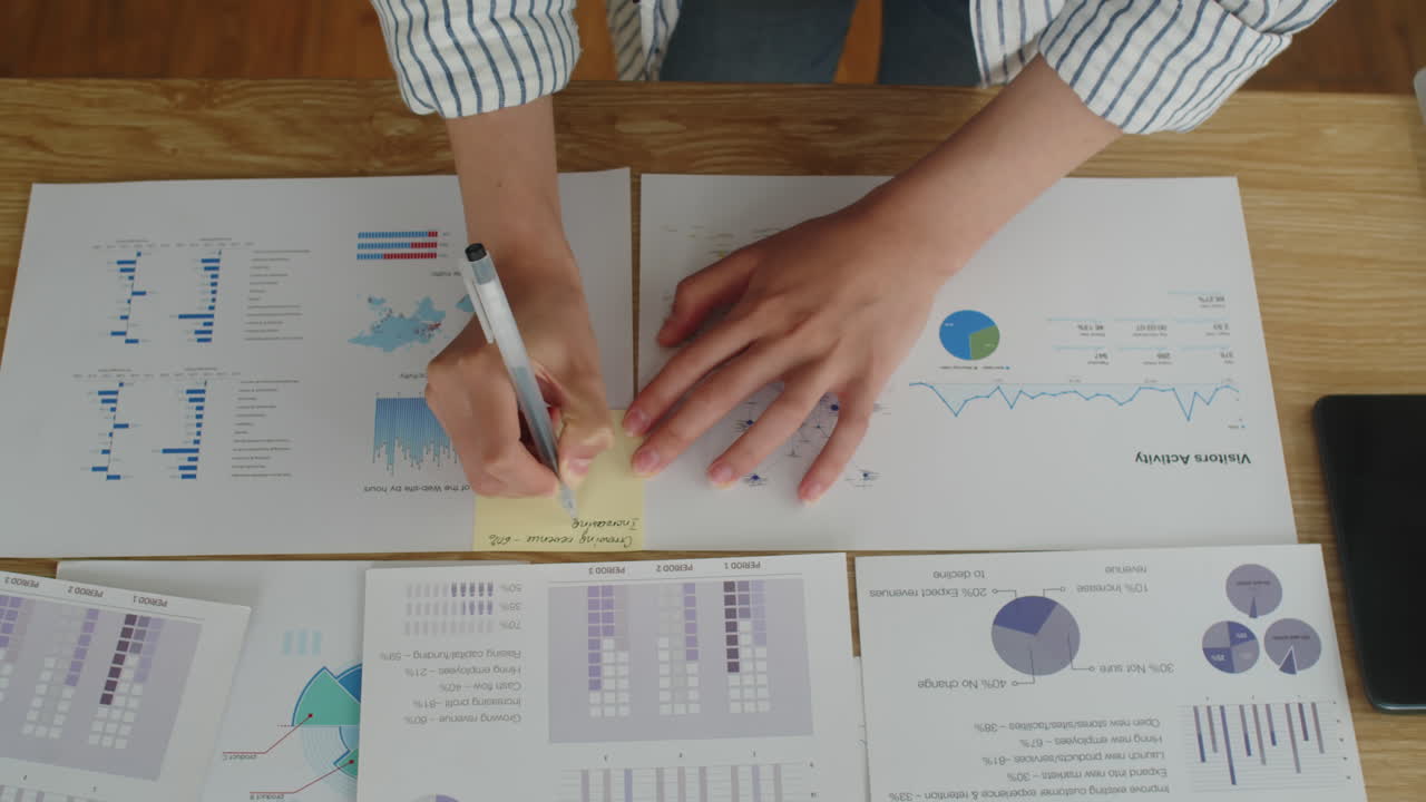 Manager Making Business Report on Table at Office