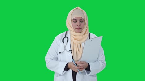 muslim doctor listening to patient green screen
