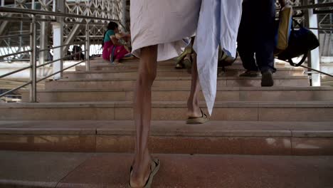 man carrying sack up steps