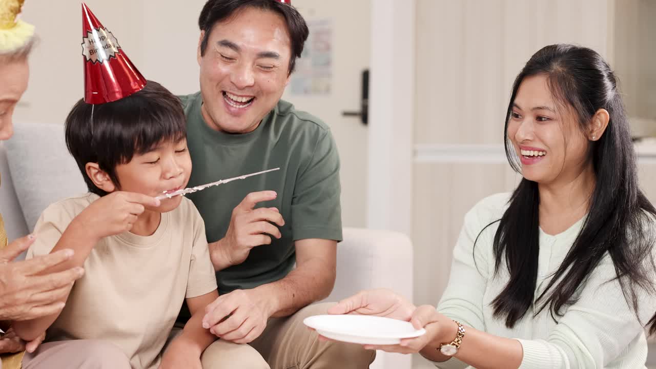 A joyful family birthday celebration with cake, laughter, and party hats in a cozy living room setting