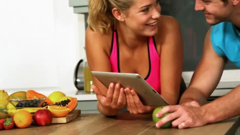 cute couple using tablet computer in the kitchen