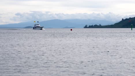 Beautiful-landscape-shot-of-a-large-boat-cruising-across-Lake-Taupo-in-New-Zealand