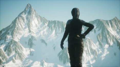 woman standing in snow wearing warm clothes in mountains