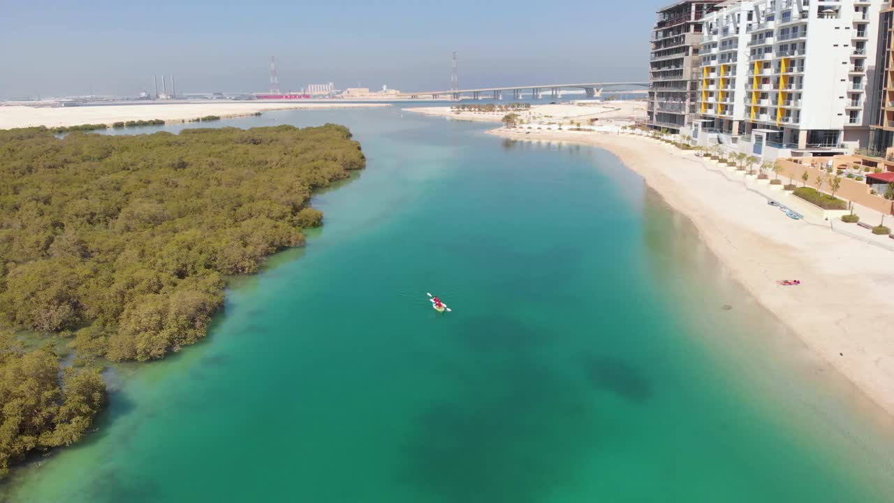 Aerial descending over Al Reem mangroves, approaching person in kayak
