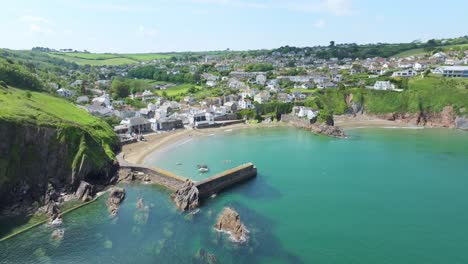 Gorran-Haven-Aerial-Drone-Shot-Orbiting-Around-the-Turquoise-Harbor-During-British-Summer