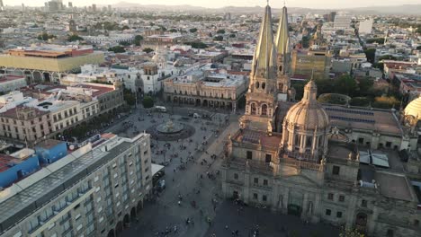 drone rotate around main cathedral square at sunset in guadalajara jalisco capital cityscape mexico aerial footage