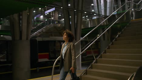 woman walking down stairs in subway station