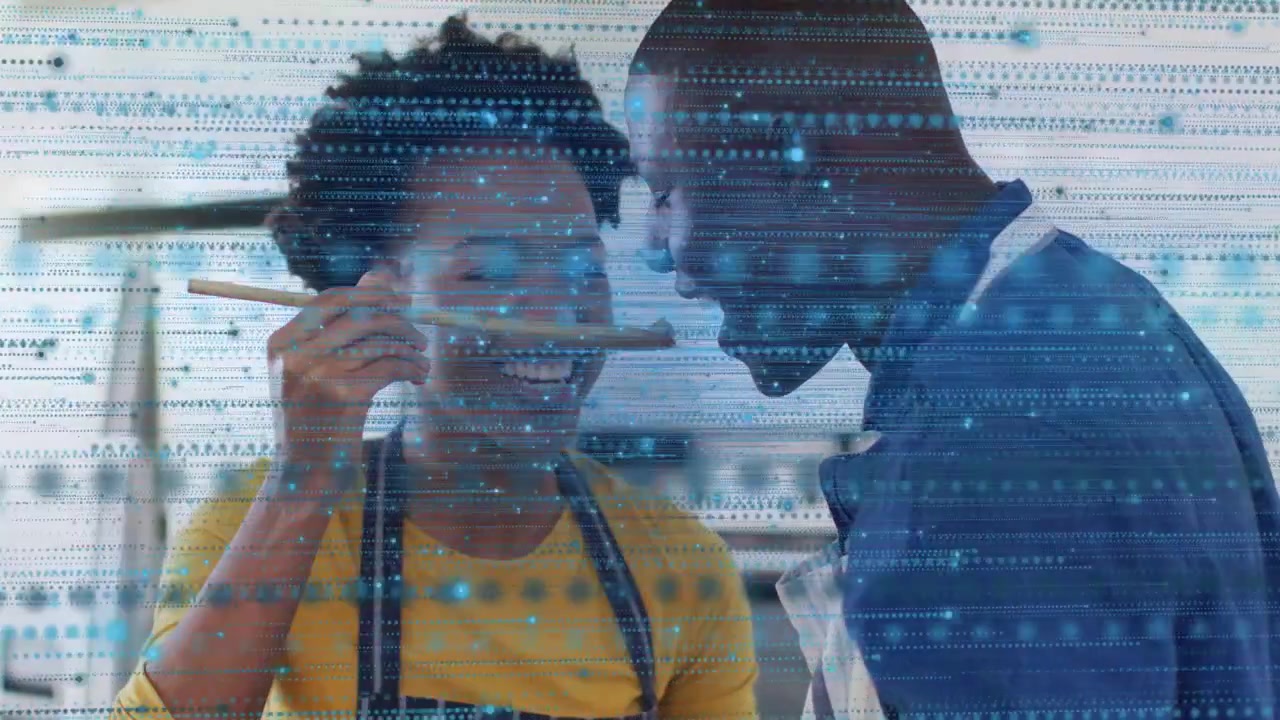 Woman offering wooden spoon, man leaning in sampling food, blue scanline overlaying, both smiling