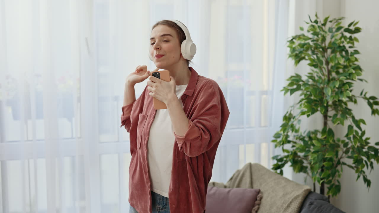 Woman Singing and Dancing with Headphones and Phone