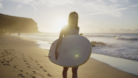 woman surfing at sunset beach