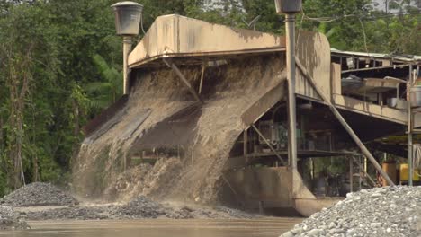 processed sand and mud spewing out of a gold dredger in to the river in checo, colombia-2