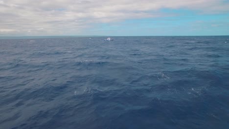 Aerial-View-of-Abandoned-Boat-in-the-Middle-of-Tropical-Sea-and-Endless-Horizon