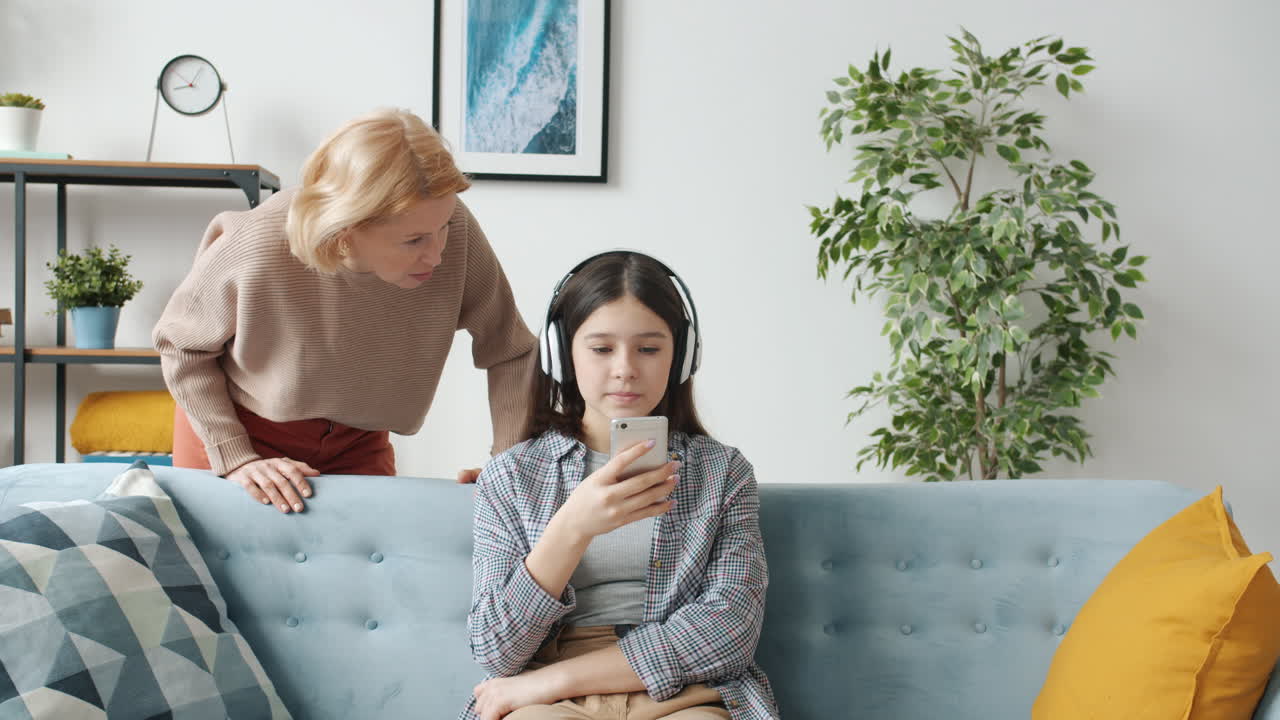 스마트폰을 사용하는 어머니와 딸