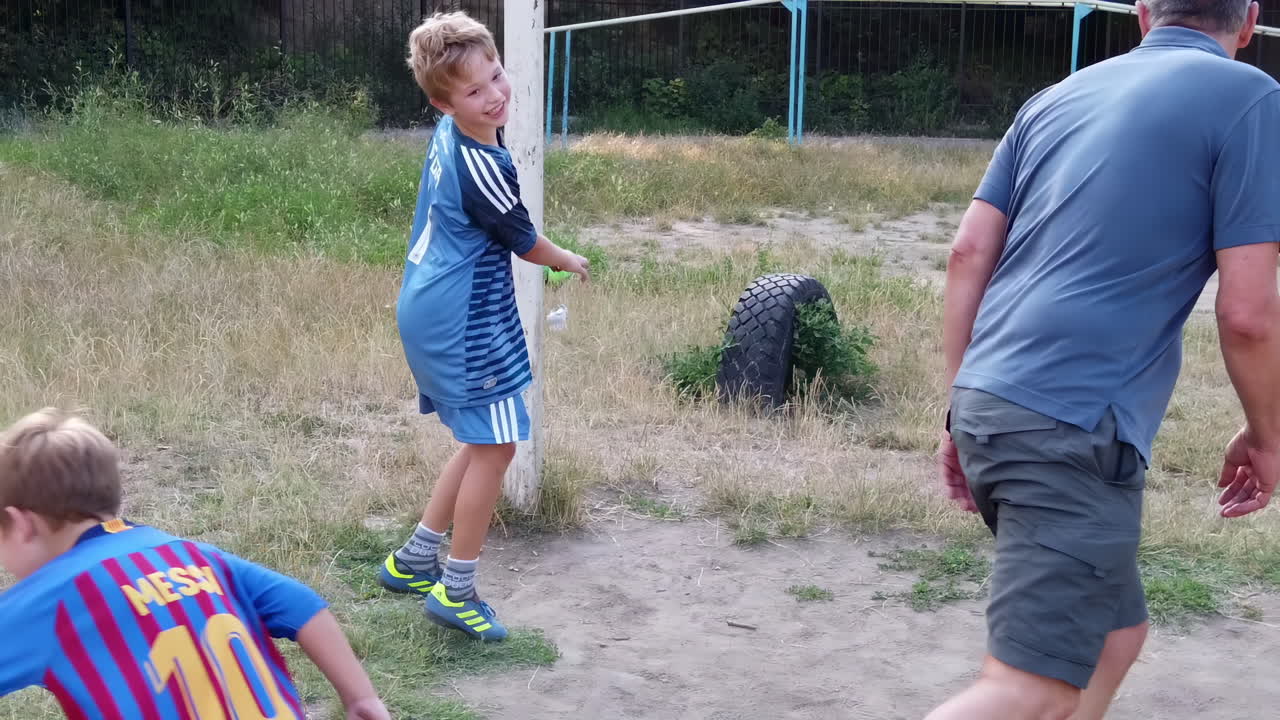 Chisnau, Moldova - August 12, 2021: Children playing football in a court outside
