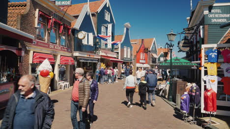 tourists stroll around dutch village