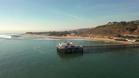 aerial of historic malibu pier, pacific coast highway and the santa monica mountains near los angeles in southern california