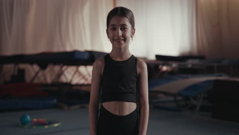 young girl in a gym smiling