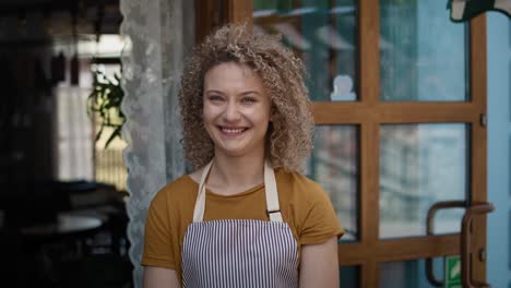 portrait of young caucasian waitress in the bakery.