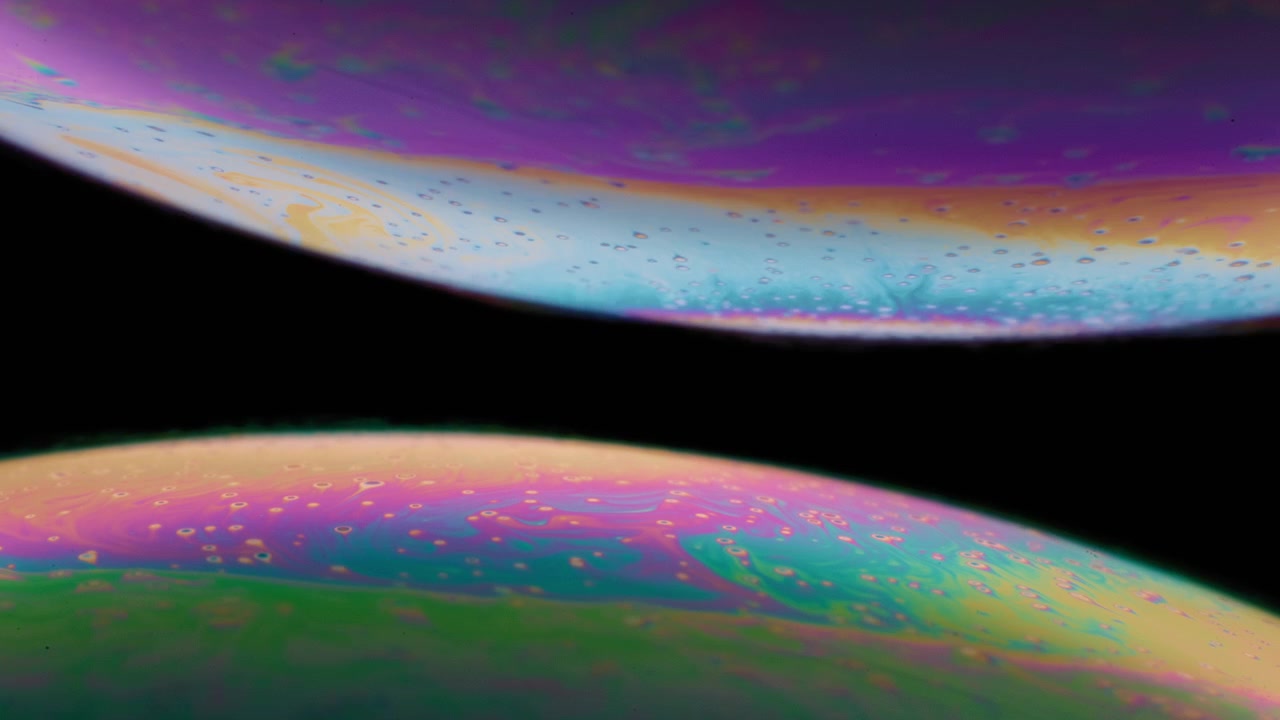 Two spheres of colorful liquid in macro
