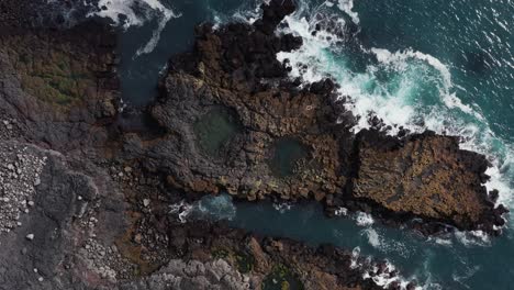 top down of wild volcanic shore of reykjanes peninsula with tide pools