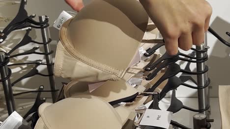 a young woman buys a bra in a lingerie store. shopping in stores.