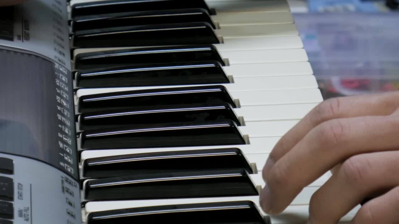 Hands playing electronic keyboard