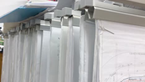 white building plans in a tray