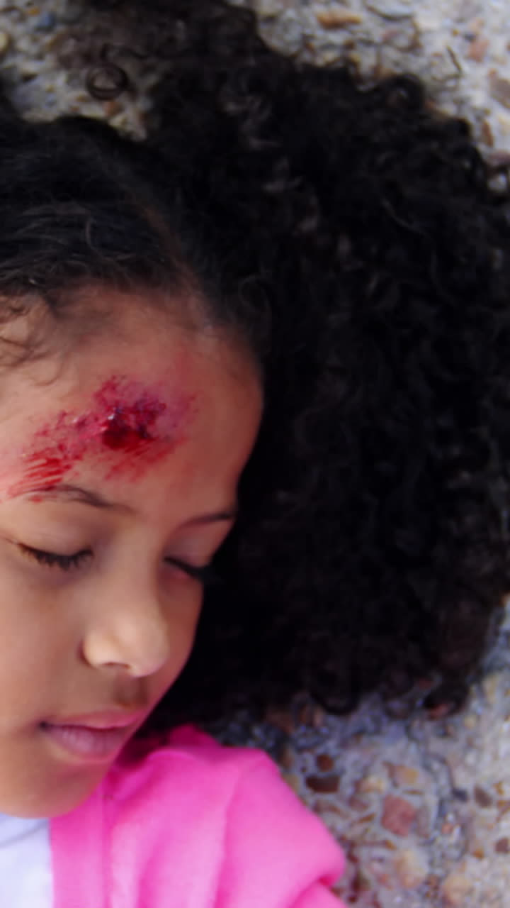 Unconscious girl fallen on ground after accident