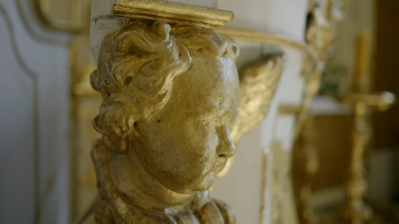 Close-up of a Golden Cherub Sculpture