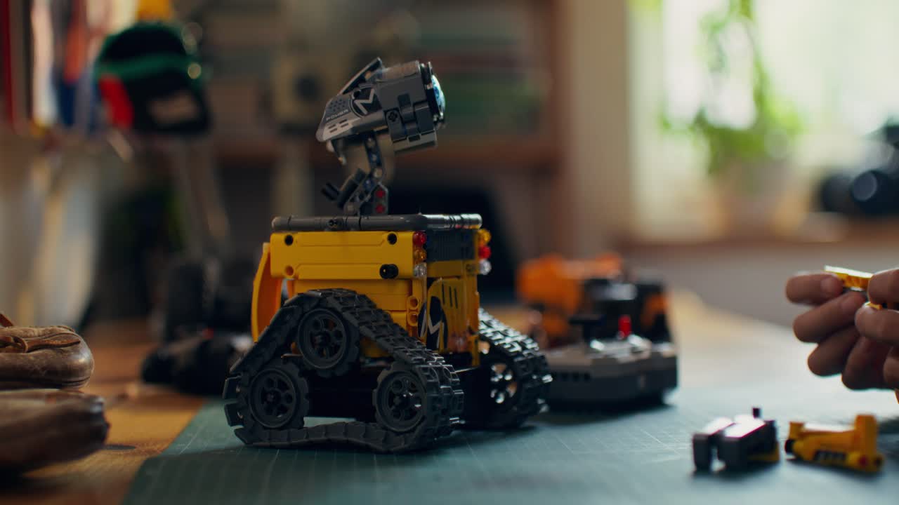 Child Building a Lego Wall-E Robot Toy