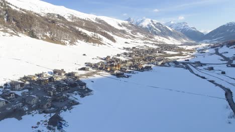 Aerial-landscape-of-a-village-of-Livigno-in-Italy,-placed-in-alpine-valley-between-high-and-steep-mountains