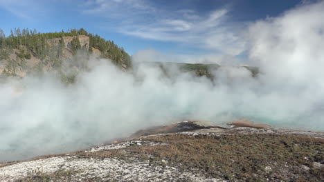 steam above hydrothermal hot springs in yellowstone national park, wyoming usa