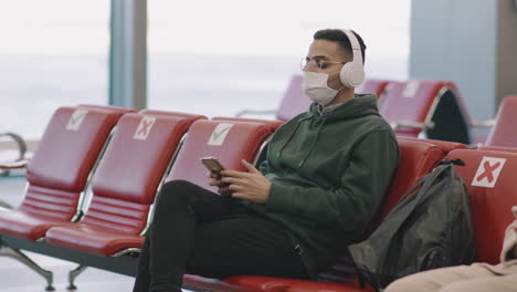 man in headphones at departure lounge