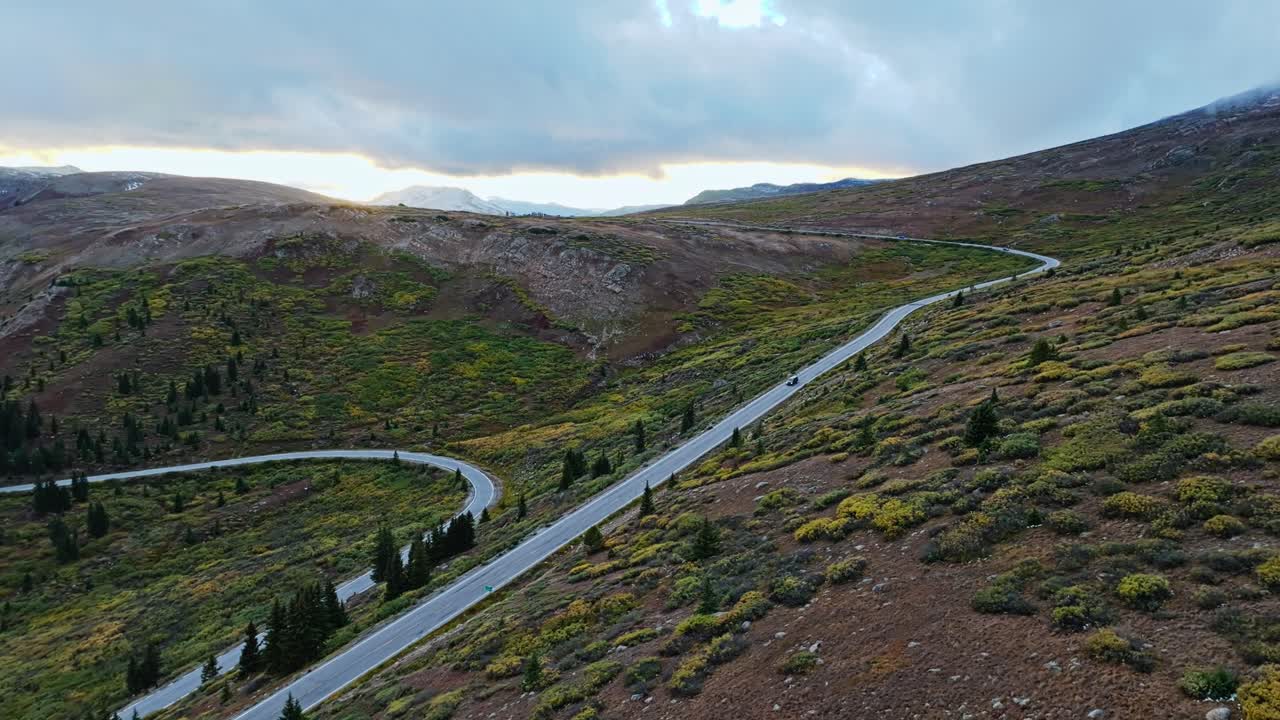 Aerial view of an open, rocky plain surrounded by snow-capped mountains in Colorado