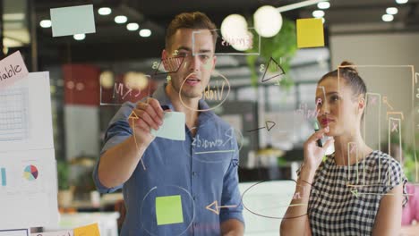 Happy-diverse-business-people-discussing-work-during-meeting-at-office