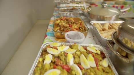 gliding over a variety of filipino foods for a potluck party