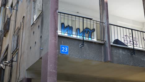 number 23 sign on a two storey old apartment building