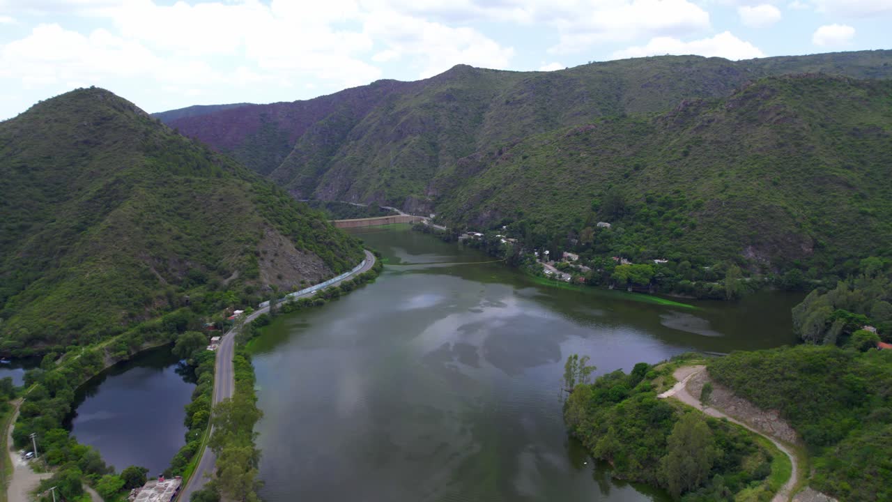 Aerial view of San Roque Lake and Dam surrounded by green mountains. Córdoba, Argentina