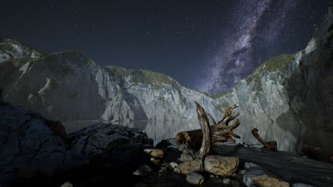 hyperlapse of night starry sky with mountain and ocean beach in lofoten norway