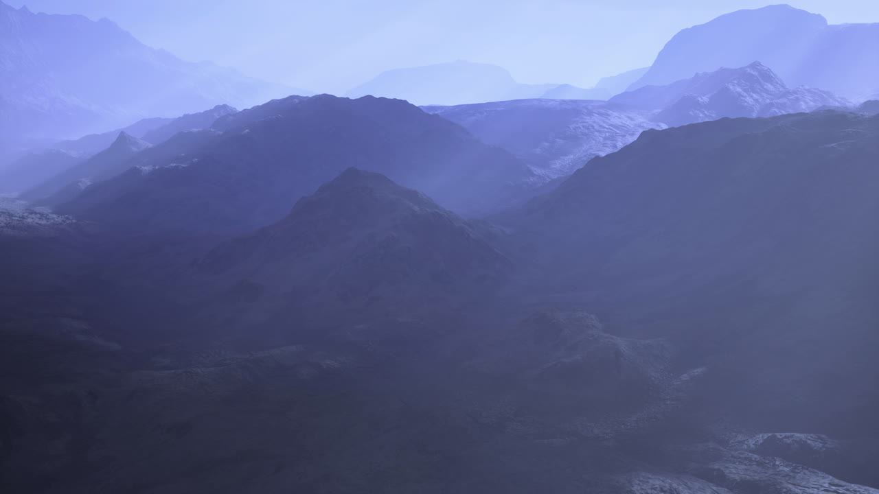 Majestic mountain landscape at dawn with a mystical blue haze surrounding peaks