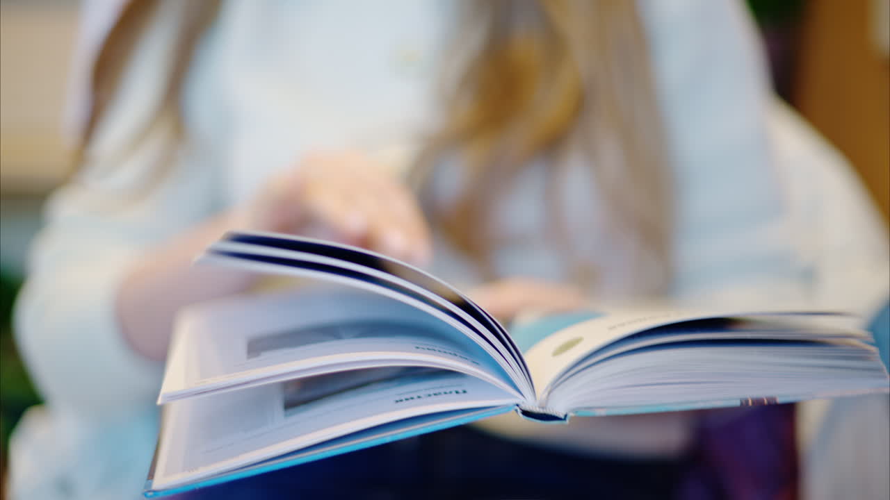 Woman reading a book at a coffee shop close up