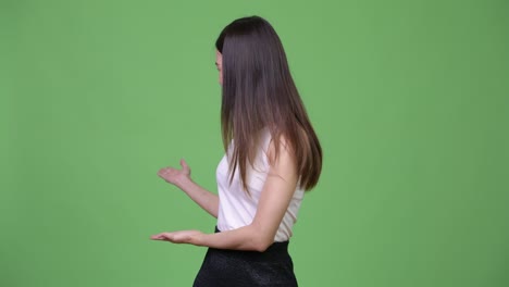 young beautiful asian businesswoman presenting something